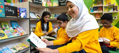 School children read books in their new primary school library
