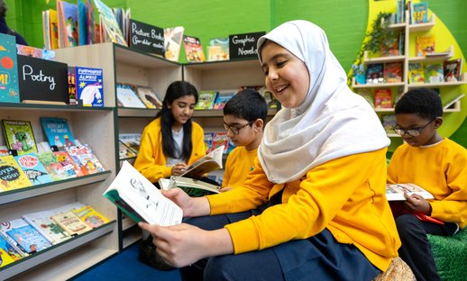 School children read books in their new primary school library