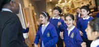School children in uniform looking excited