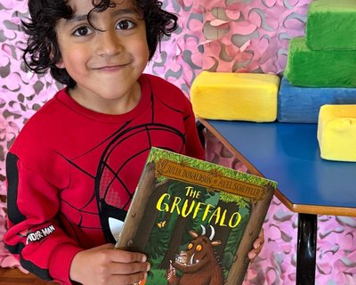 EWM The Gruffalo Birmingham_boy holds book and smiles