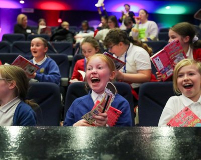 Children clutch new books and beam with excitement at our first ever Pupil Librarian conference
