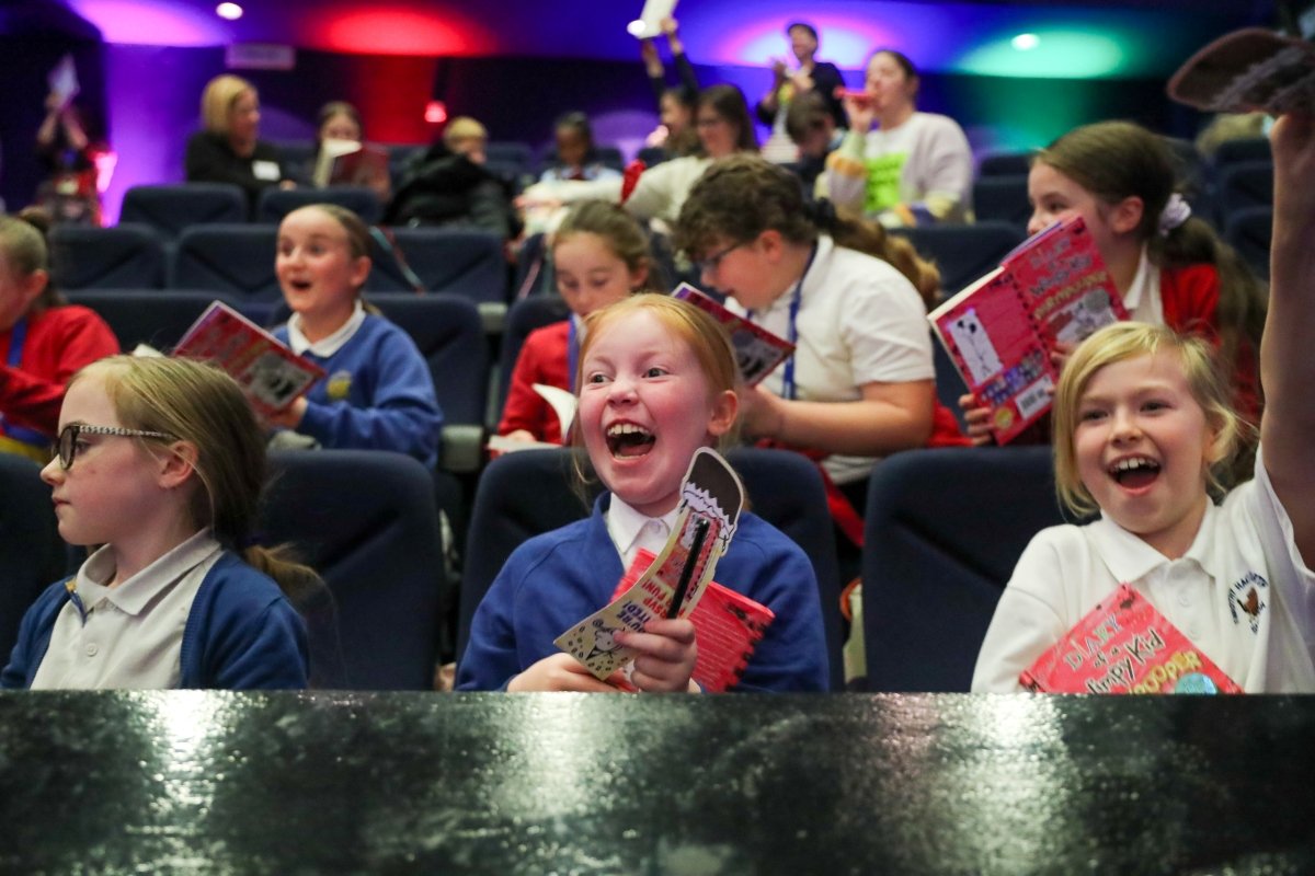 Children clutch new books and beam with excitement at our first ever Pupil Librarian conference