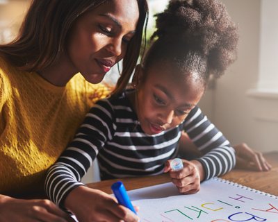 Mum and daughter writing