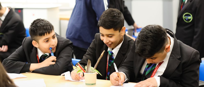 Secondary boys writing in classroom