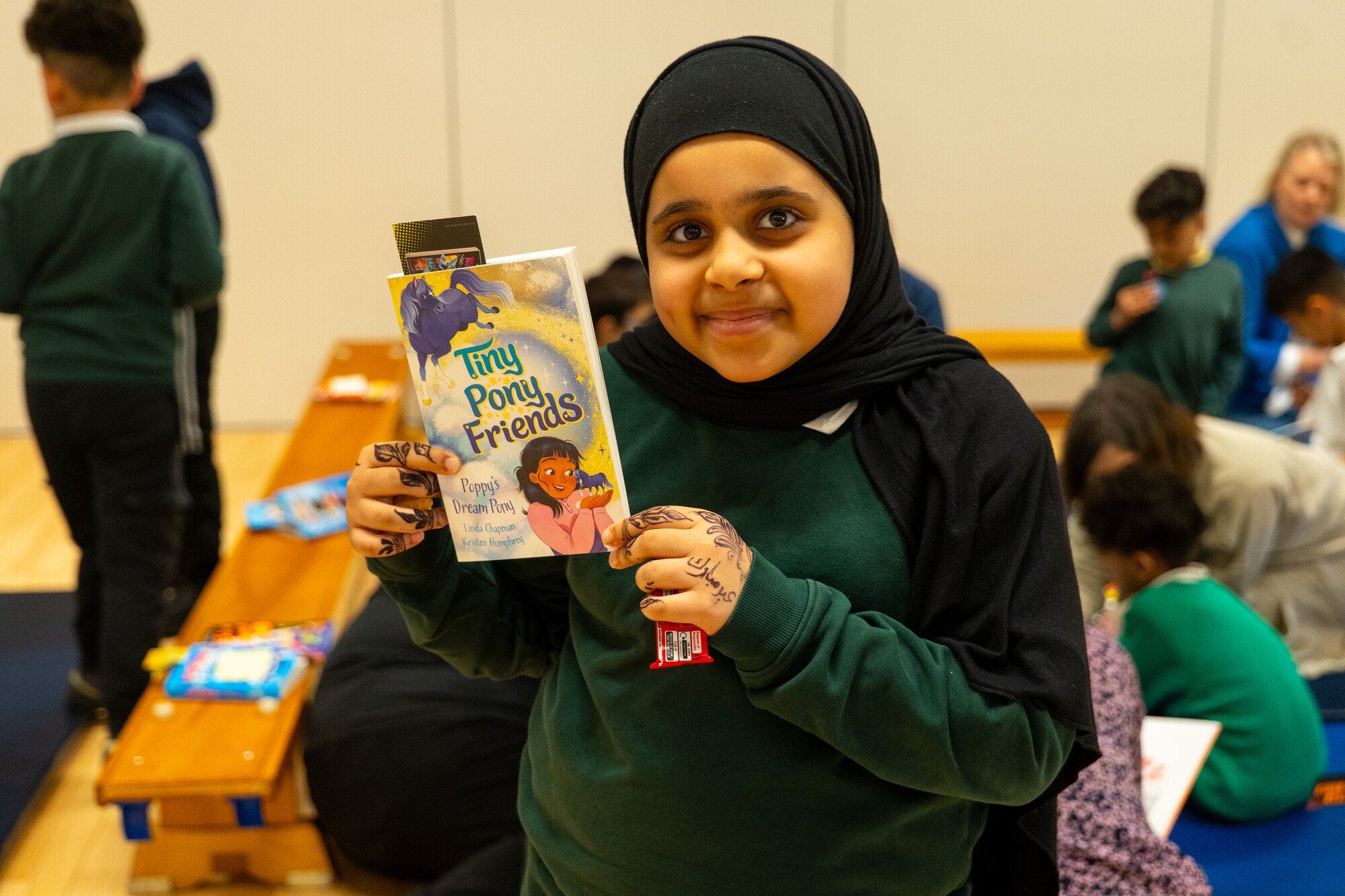 A child with her Raising Readers book