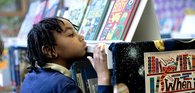 Child looking at books in a library