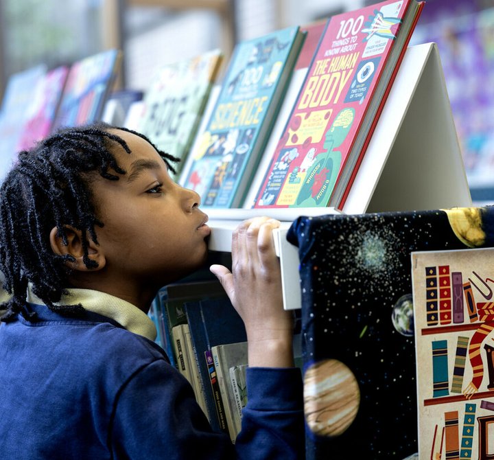 Child looking at books in a library