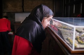 Primary pupil looking at a museum exhibit as part of Goldsmiths 500 Young Writers
