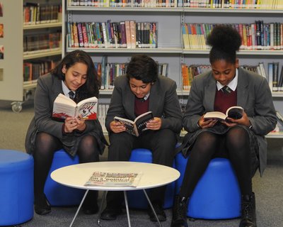 Secondary pupils reading in a library
