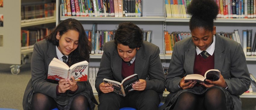 Secondary pupils reading in a library