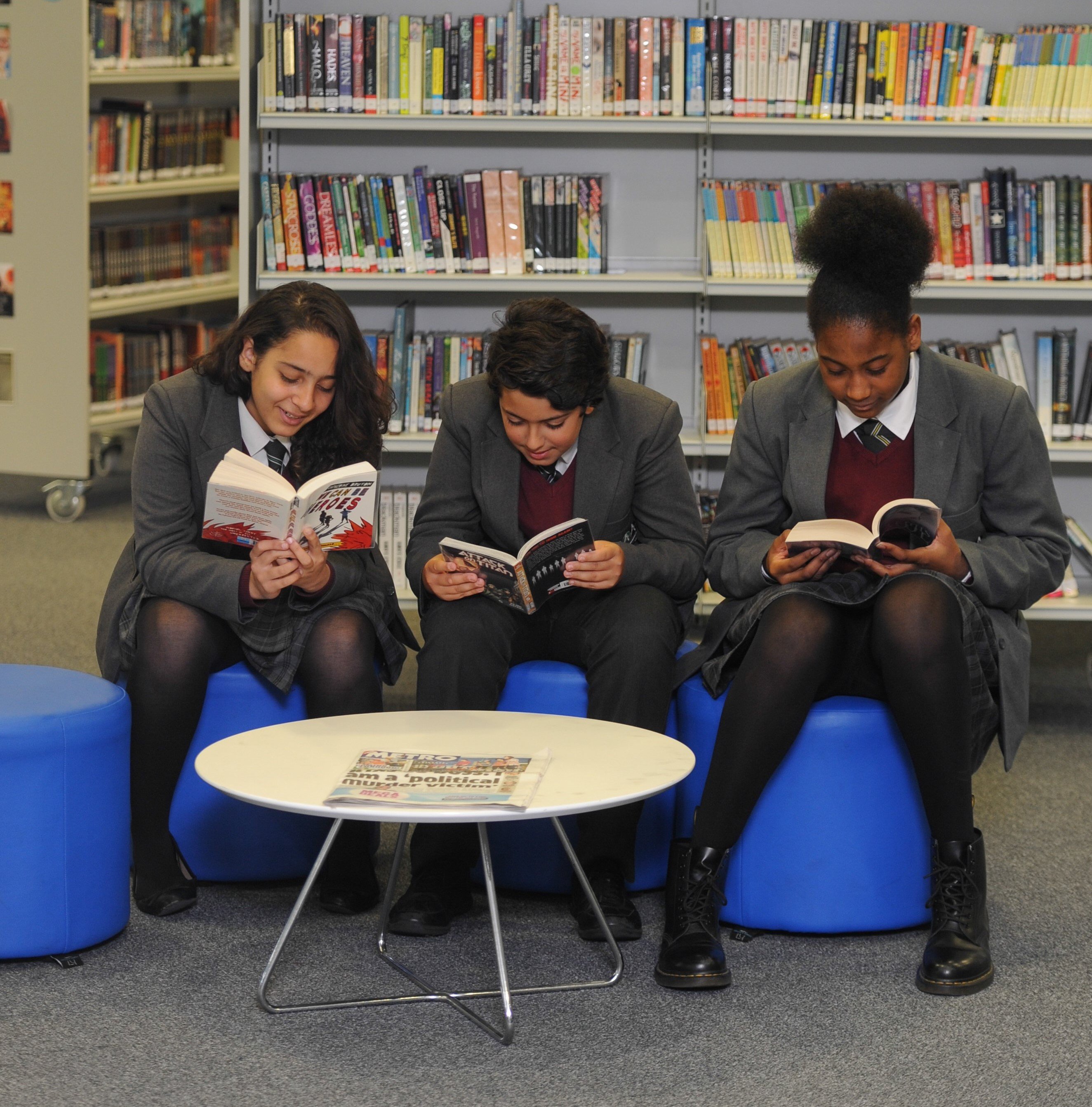 Secondary pupils reading in a library