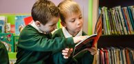 Primary boys share a book