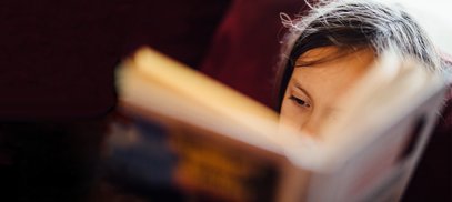 Close up of a young child reading a book