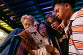Young people look at comic book together