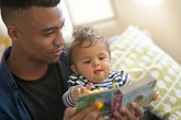 dad and baby reading