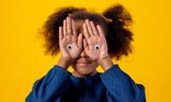 Child with googly eyes on hands_comic relief_pexels